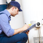 Technician repairing an hot-water heater